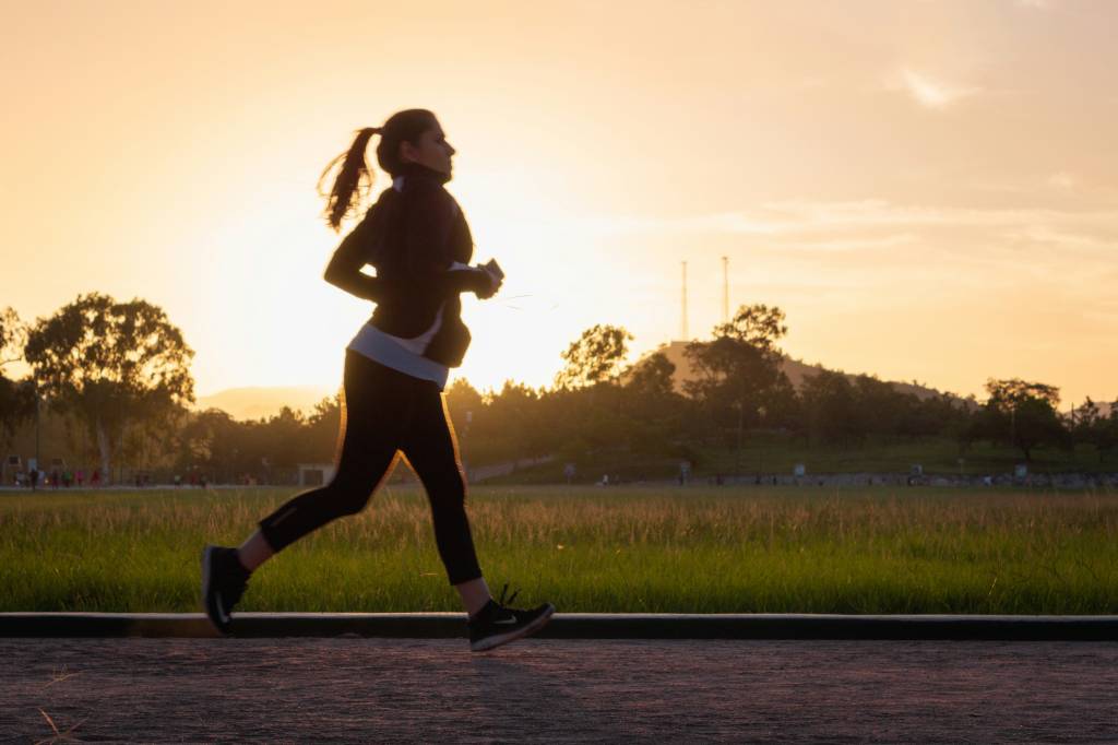 pregnant woman runs along road