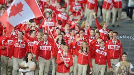Simon Whitfield carries Canada’s Olympic flag