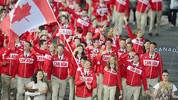 Simon Whitfield carries Canada’s Olympic flag