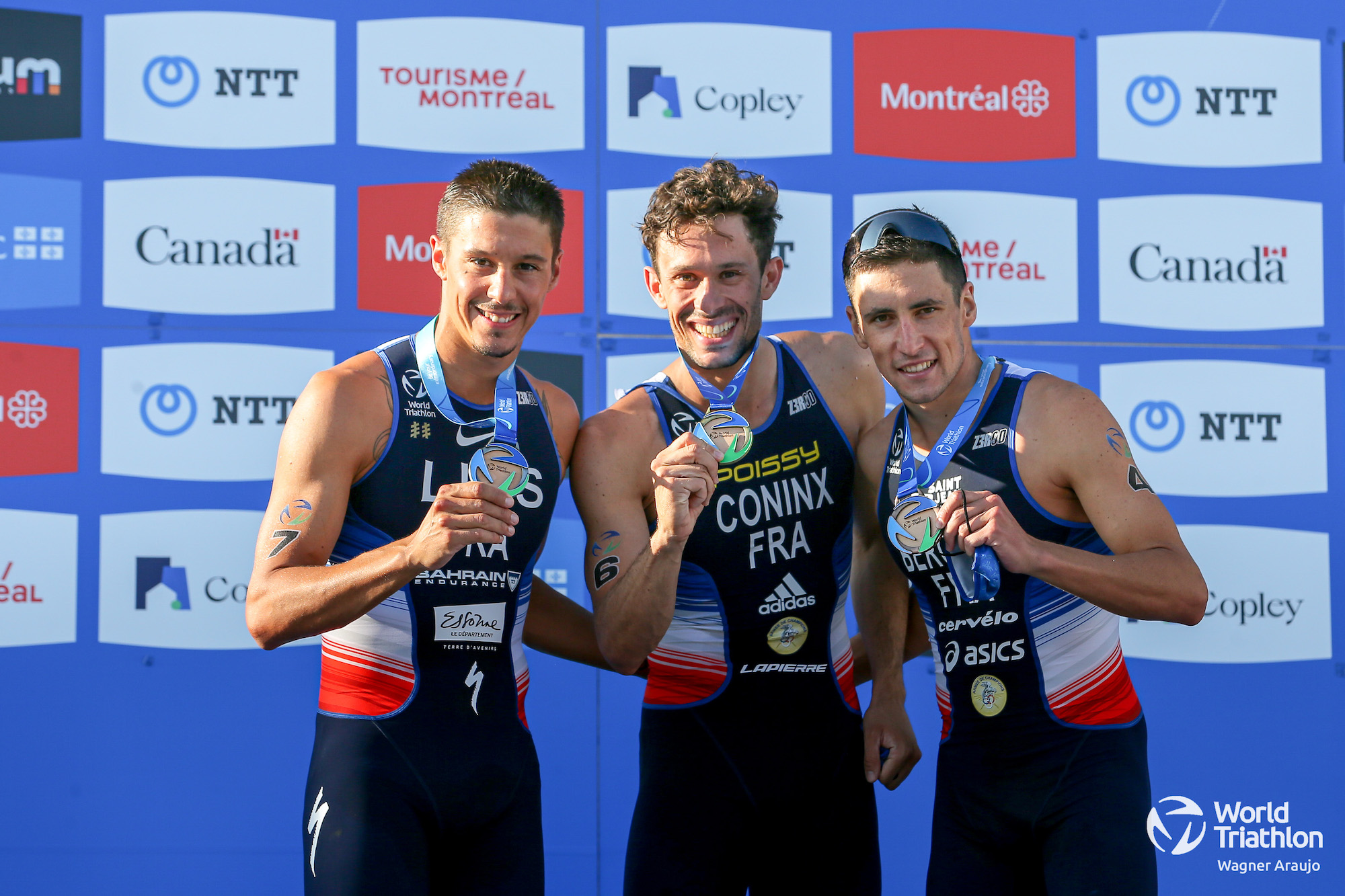 mens-podium-wtcs-montreal L-R: Vincent Luis (silver), Dorian Coninx (gold) and Leo Bergere (bronze) holding their respective medals on the podium of the 2021 Montreal World Triathlon race