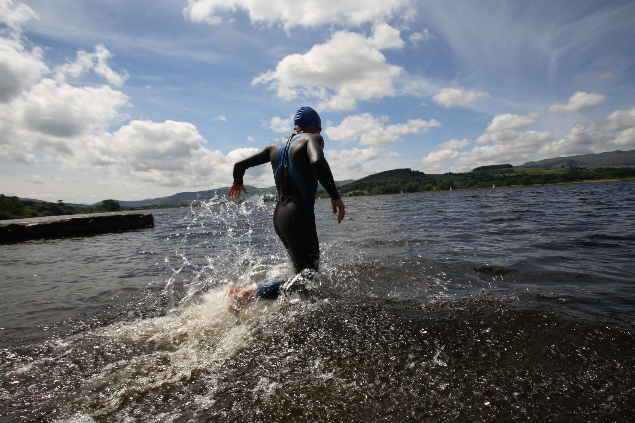 Triathlete swimmer running into water