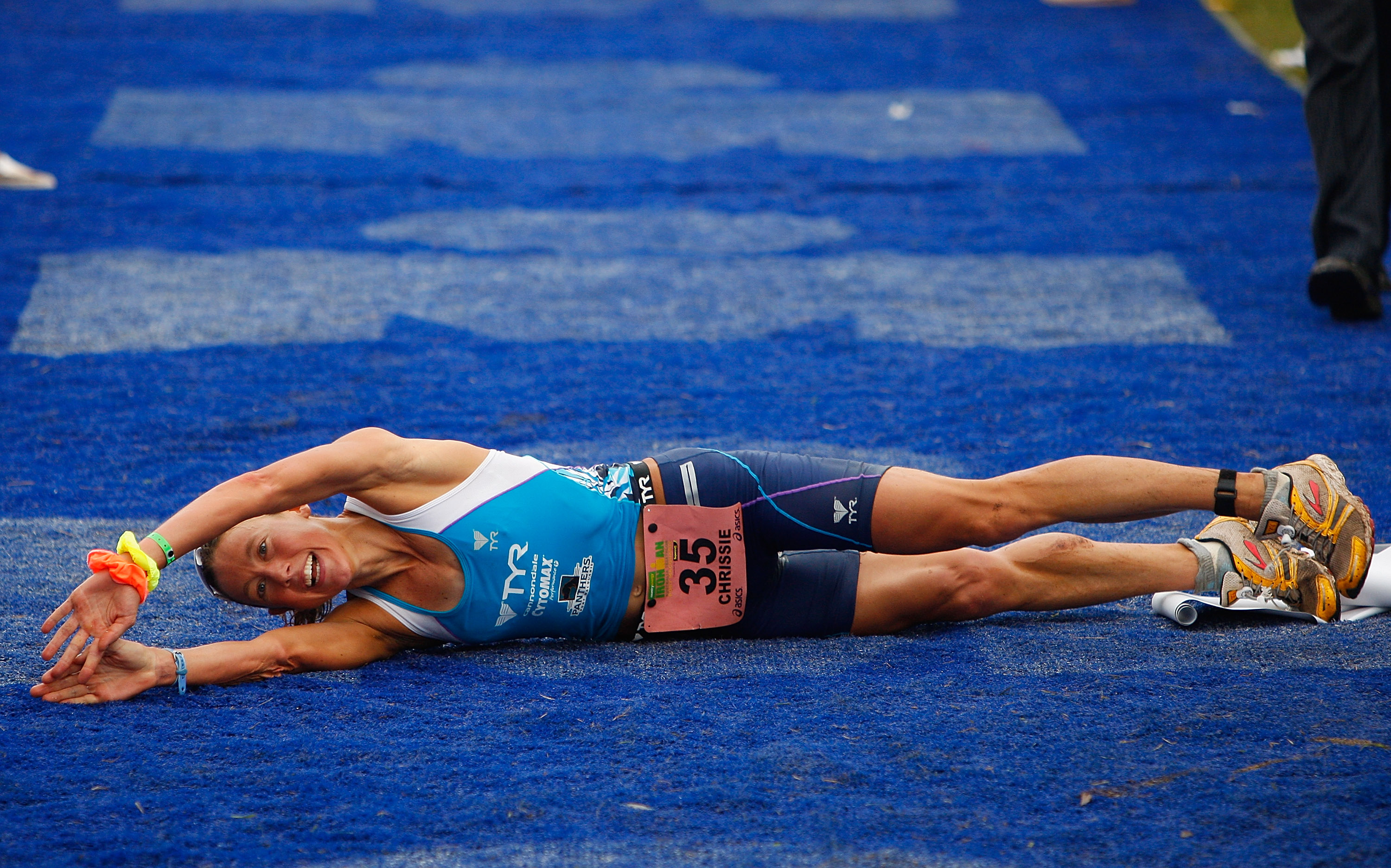 2009 Ironman Australia PORT MACQUARIE, AUSTRALIA - APRIL 05: Chrissie Wellington of the United Kingdom rolls across the finish line to cross in first place for women in the 2009 Ironman Australia on April 5, 2009 in Port Macquarie, Australia. (Photo by Cameron Spencer/Getty Images)