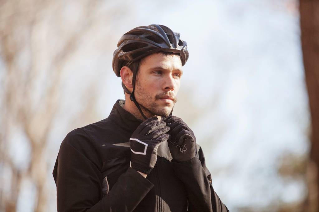 Cyclist putting on a helmet