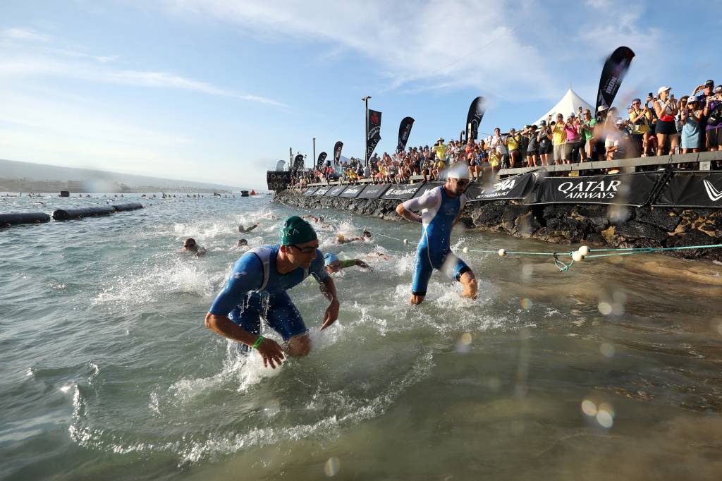 KAILUA KONA, HAWAII - OCTOBER 08: Patrick Lange of Germany and Sam Laidlow of France are the first out of the water during the IRONMAN World Championships on October 08, 2022 in Kailua Kona, Hawaii.