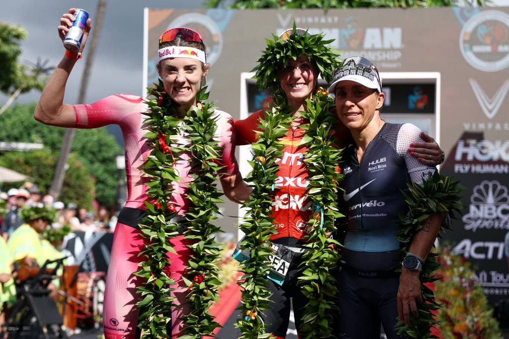 KAILUA KONA, HAWAII - OCTOBER 06: Lucy Charles-Barclay of Great Britain (2nd), Chelsea Sodaro (1st) and Anne Haug of Germany (3rd) celebrate after finishing the Ironman World Championships on October 06, 2022 in Kailua Kona, Hawaii.