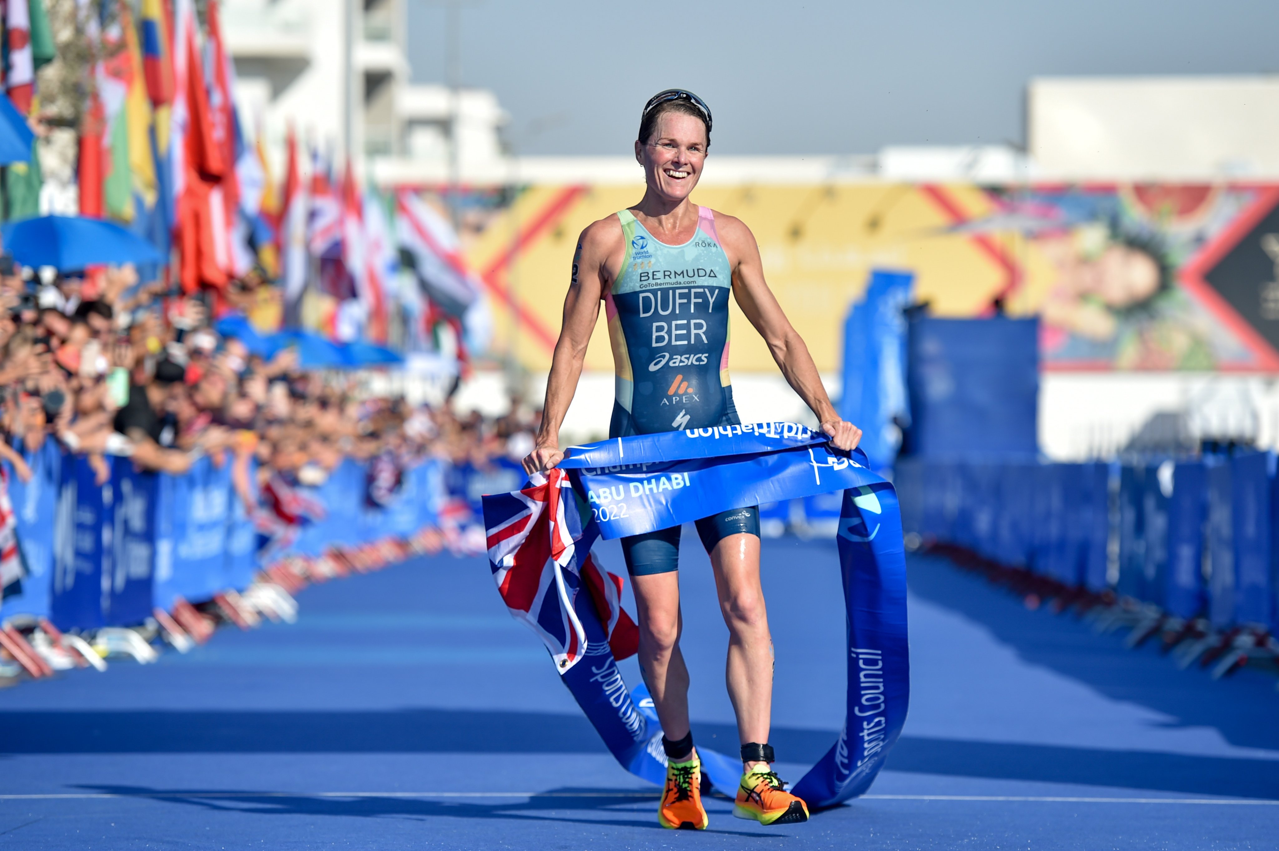 Bermudan triathlete Flora Duffy crosses the line at the 2022 World Triathlon Grand Final in Abu Dhabi to take her fourth world title