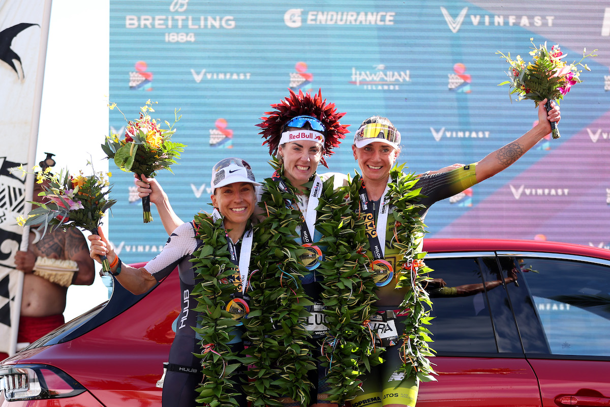 L-R: Anne Haug (2nd), Lucy Charles-Barclay (1st) and Laura Philipp (3rd) celebrate on the 2023 Ironman World Championship podium, in Kailua Kona, Hawaii.