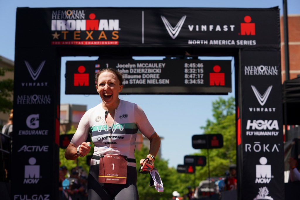 American pro triathlete Jocelyn McCauley celebrates finishing third at the 2023 Ironman Texas