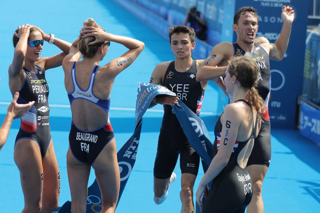France's Dorian Connix (rear R) crosses the finish line ahead of Britain's Alex Yee (rear L) to win the 2019 ITU World triathlon mixed relay series Tokyo, a test event ahead of Tokyo 2020 Olympic Games, at Odaiba in Tokyo on August 18, 2019
