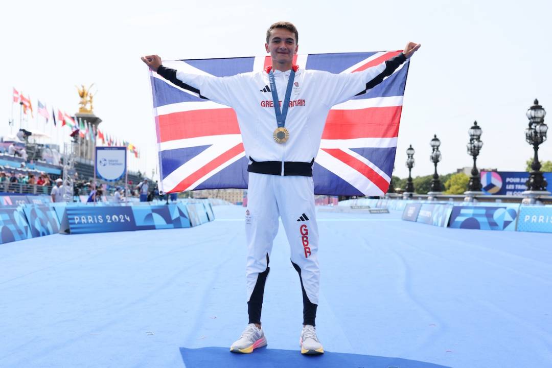 Gold medalist Alex Yee of Team Great Britain poses for a photo during the Triathlon medal ceremony after the Men's Individual on day five of the Olympic Games Paris 2024 at Pont Alexandre III on July 31, 2024 in Paris, France