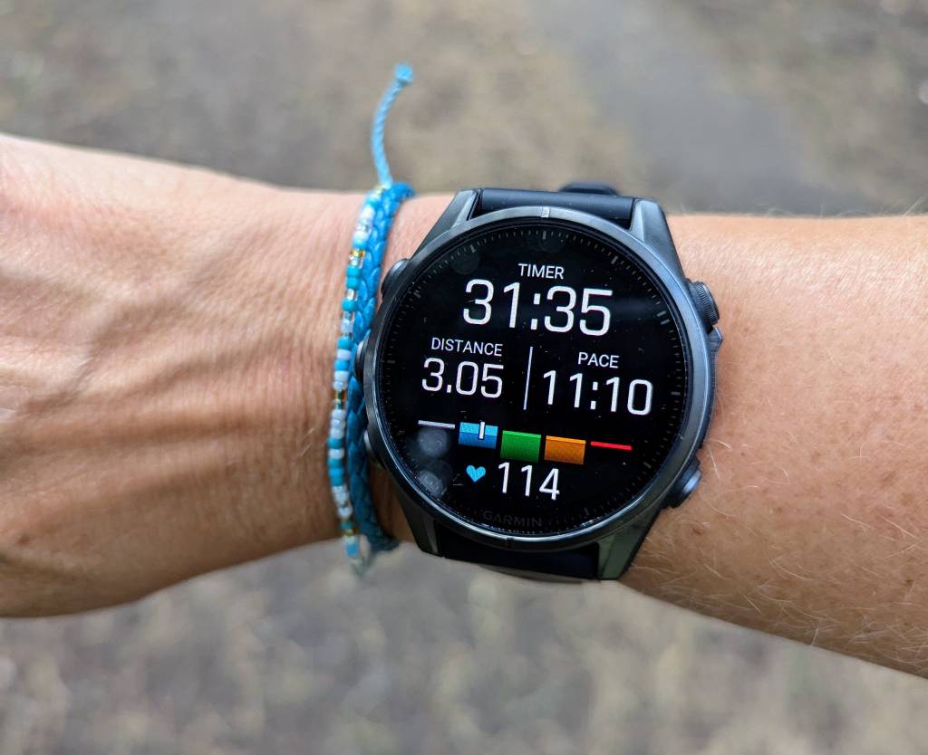 Garmin Fenix 8 on a running screen on female tester's wrist