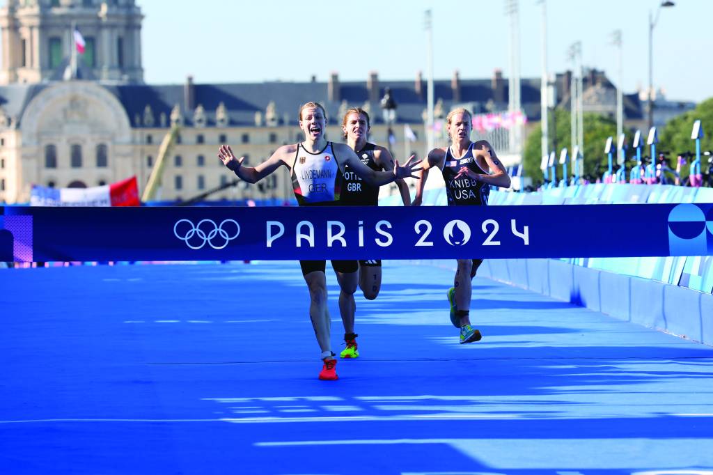 athletes crossing the line at the paris 2024 olympics for triathlon