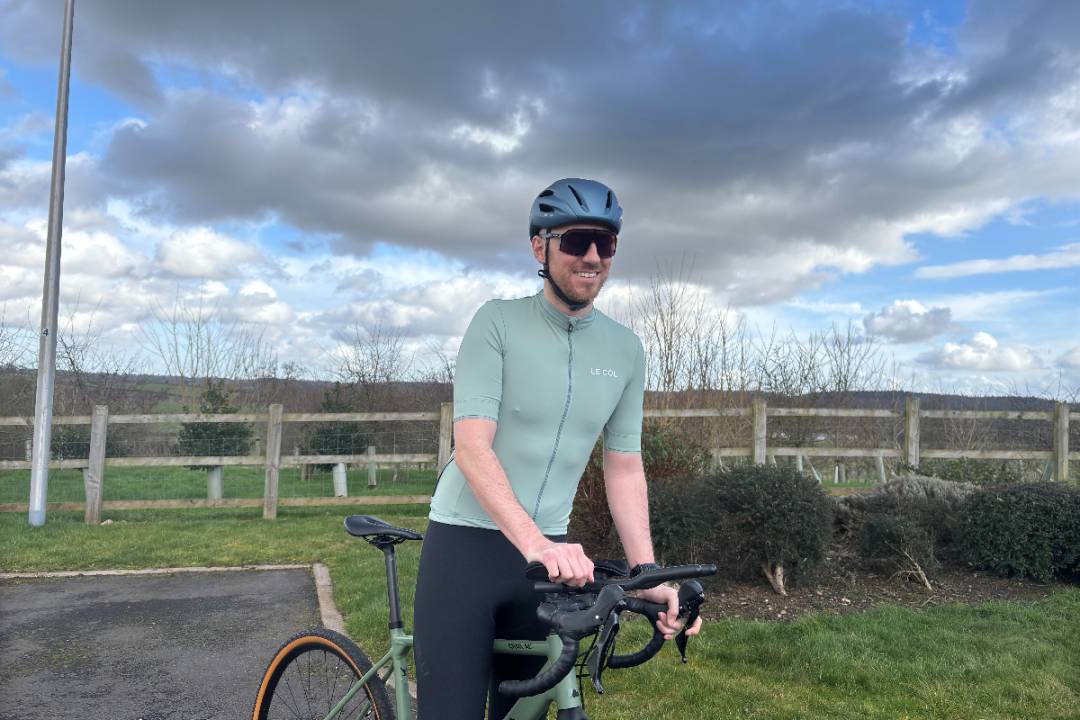 Smiling male cyclist wearing light green jersey