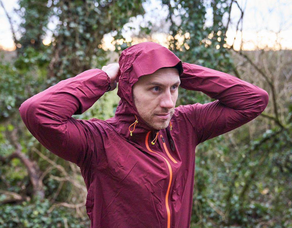 Male runner wearing purple hooded jacket