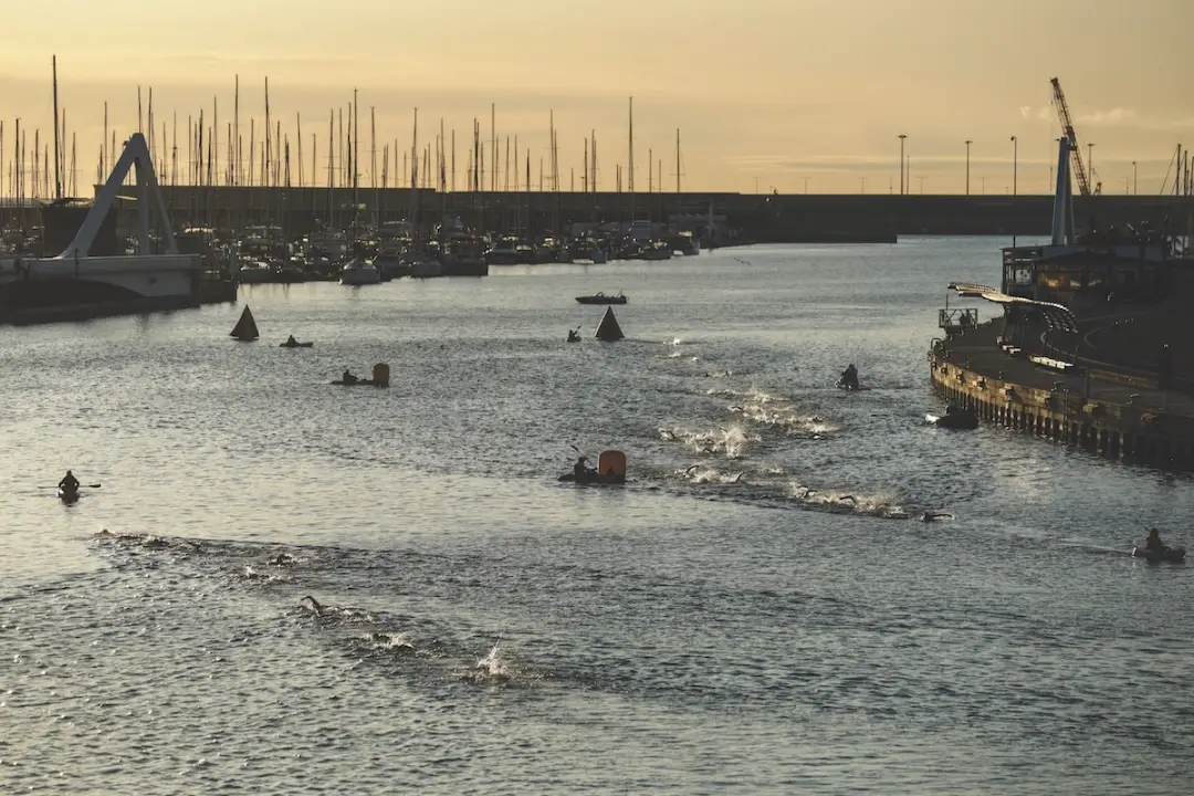 VALENCIA, SPAIN - APRIL 27: Pro men (R) and Pro women athletes compete during the swim leg of IRONMAN 70.3 Valencia on April 27, 2025 in Valencia, Spain.