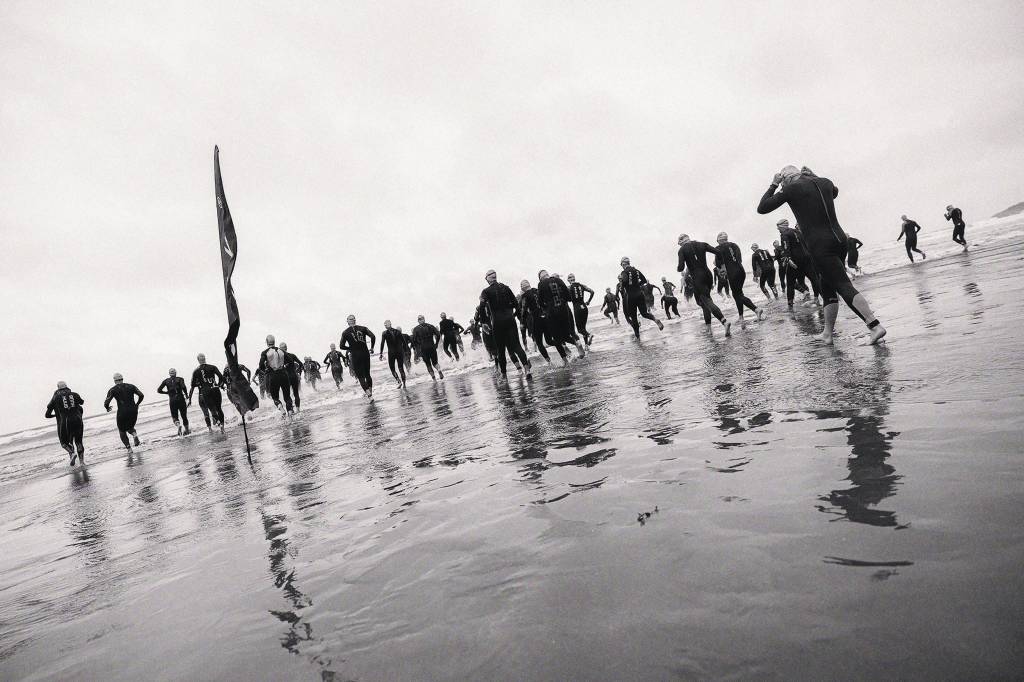 triathletes going into the water