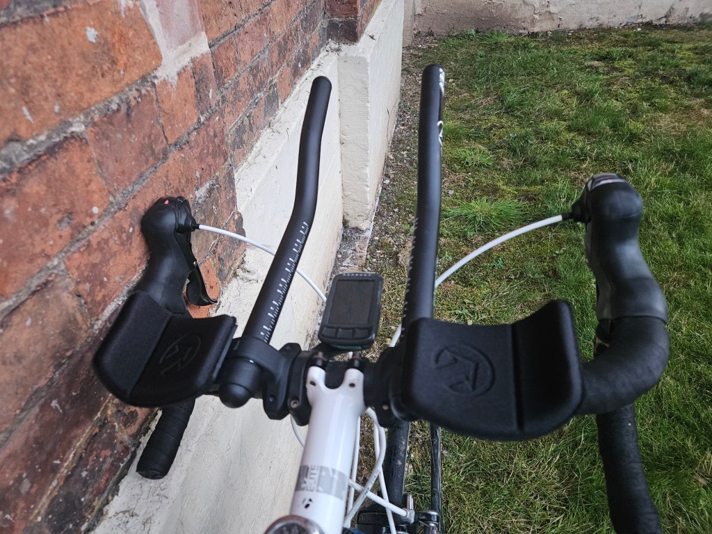 rider view of clip-on aerobars attached to road bike cockpit