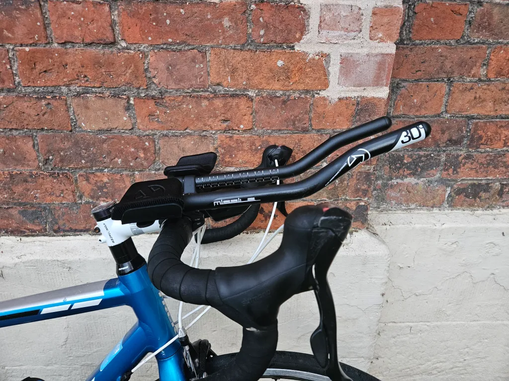 Blue road bike with clip-on aerobars