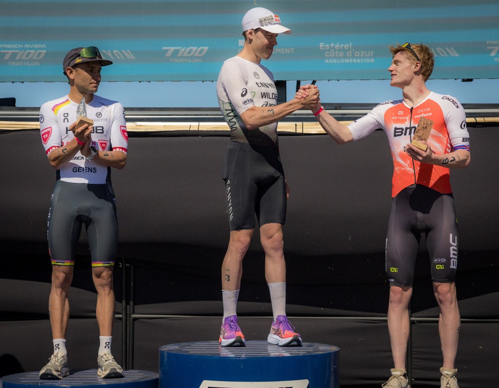 Male triathletes stand on podium of French Riviera T100