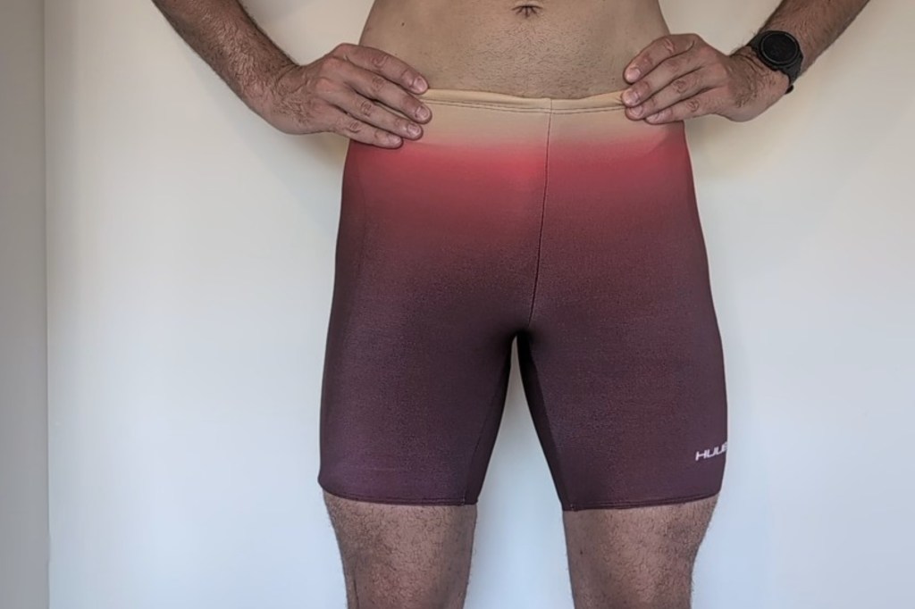 Man wearing red and pink swim jammer