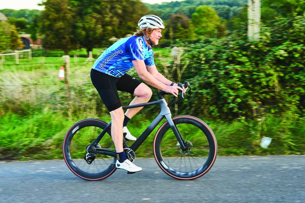Man riding black and grey road bike