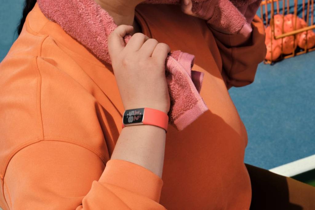 Woman training using red fitness tracker