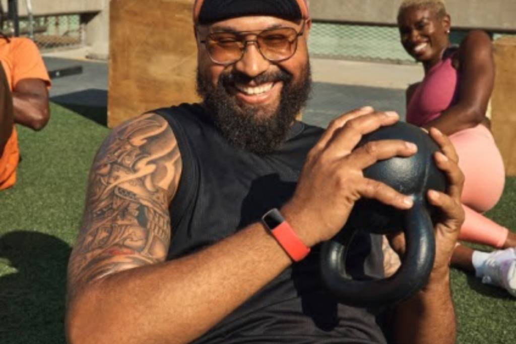 Man working out wearing red fitness tracker