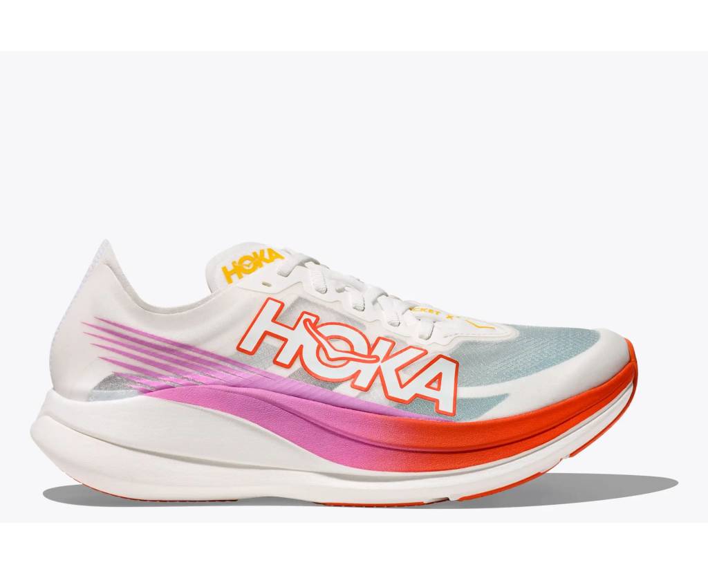 Side-on shot of white running shoe with pink and red stripe