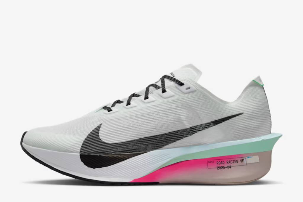 Side-on view of white running shoes with pink stripe