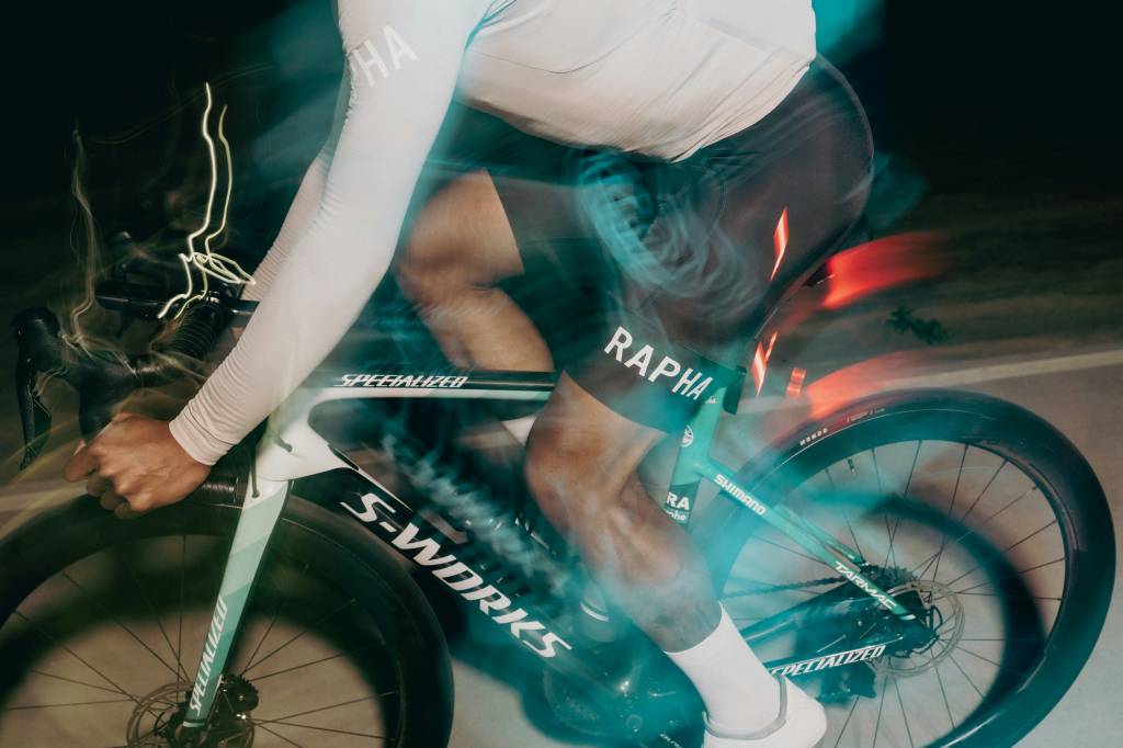 Blurred image of cyclist on road bike at night