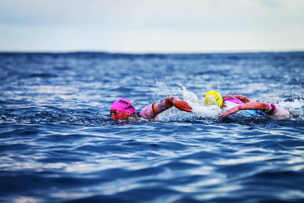 Triathletes swim during the 2025 Ironman World Championships