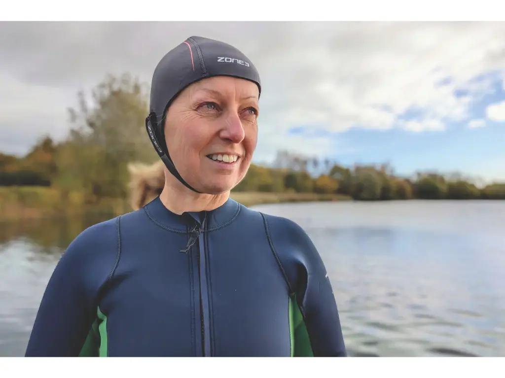 Woman wearing grey and orange swim hat