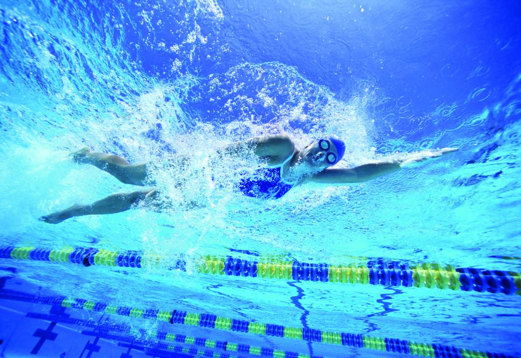 Female swimmer in United States swimsuit while swimming in pool