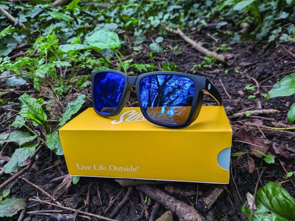 Head on view of black sunglasses on yellow box