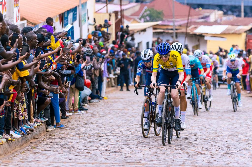 Road cyclists race up cobbled climb