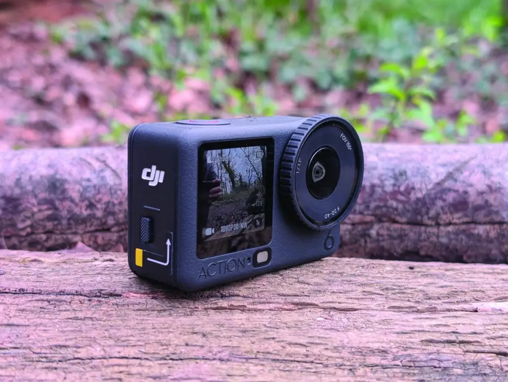 Three-quarter shot of black action camera on log
