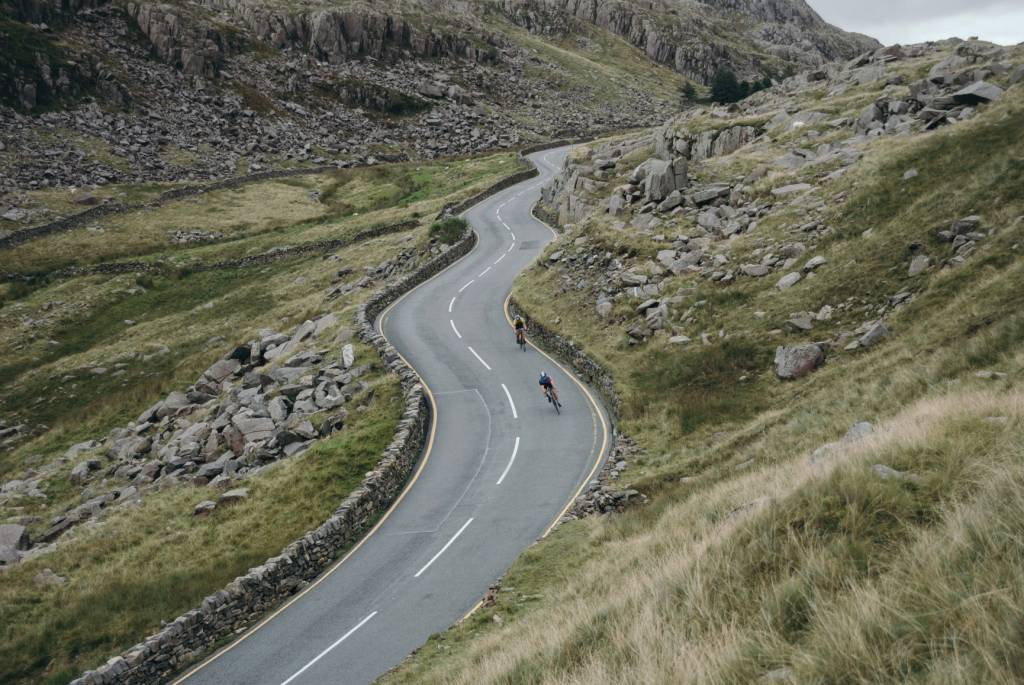 Cyclists riding down a winding road