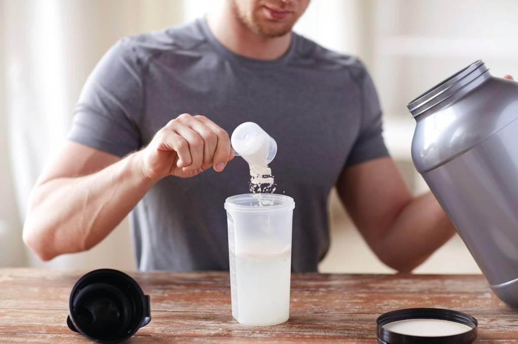 Close-up of a man making a protein shake