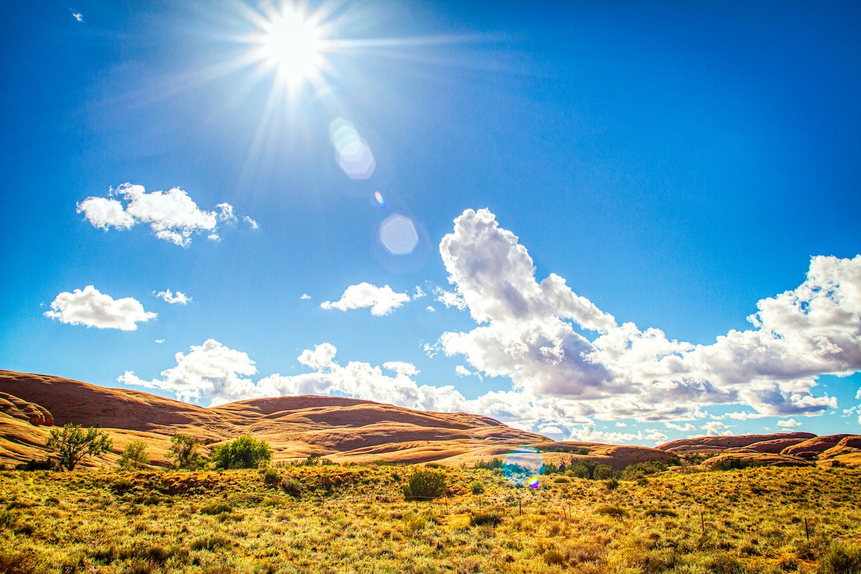 Sunshine and blue sky over rolling hills