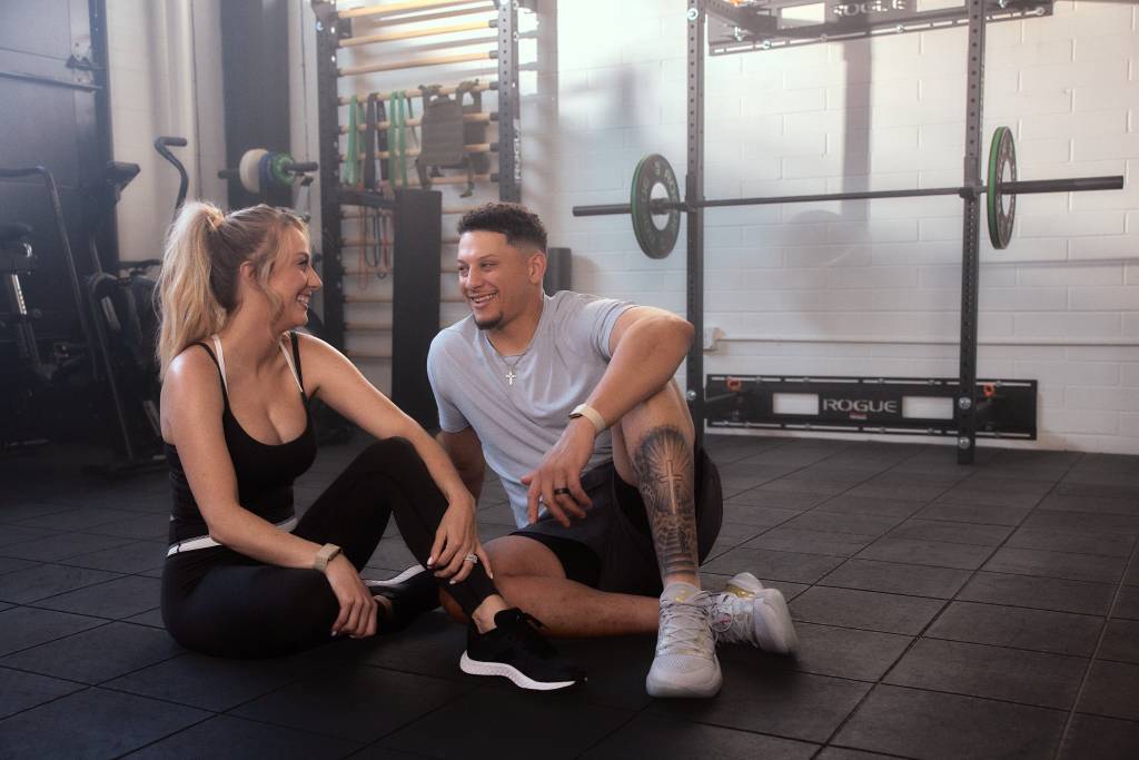 Two people in the gym wearing the WHOOP 5.0