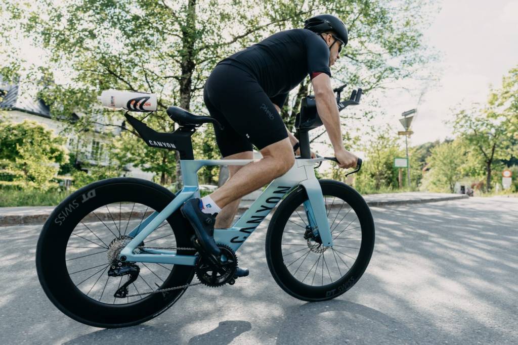 Close-up of a man riding a tri bike
